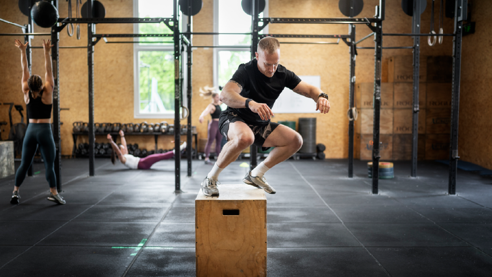 Athlete performing box jumps during 26.1 CrossFit Open workout